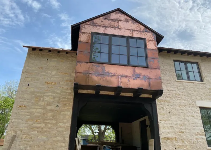 Copper metal panel facade on a stone building for Skylight Installation in Glendora